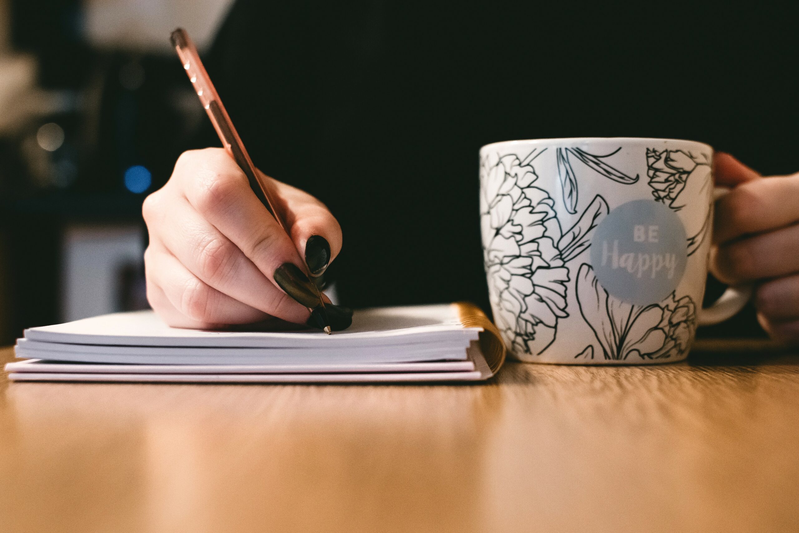 Cup with a person writing